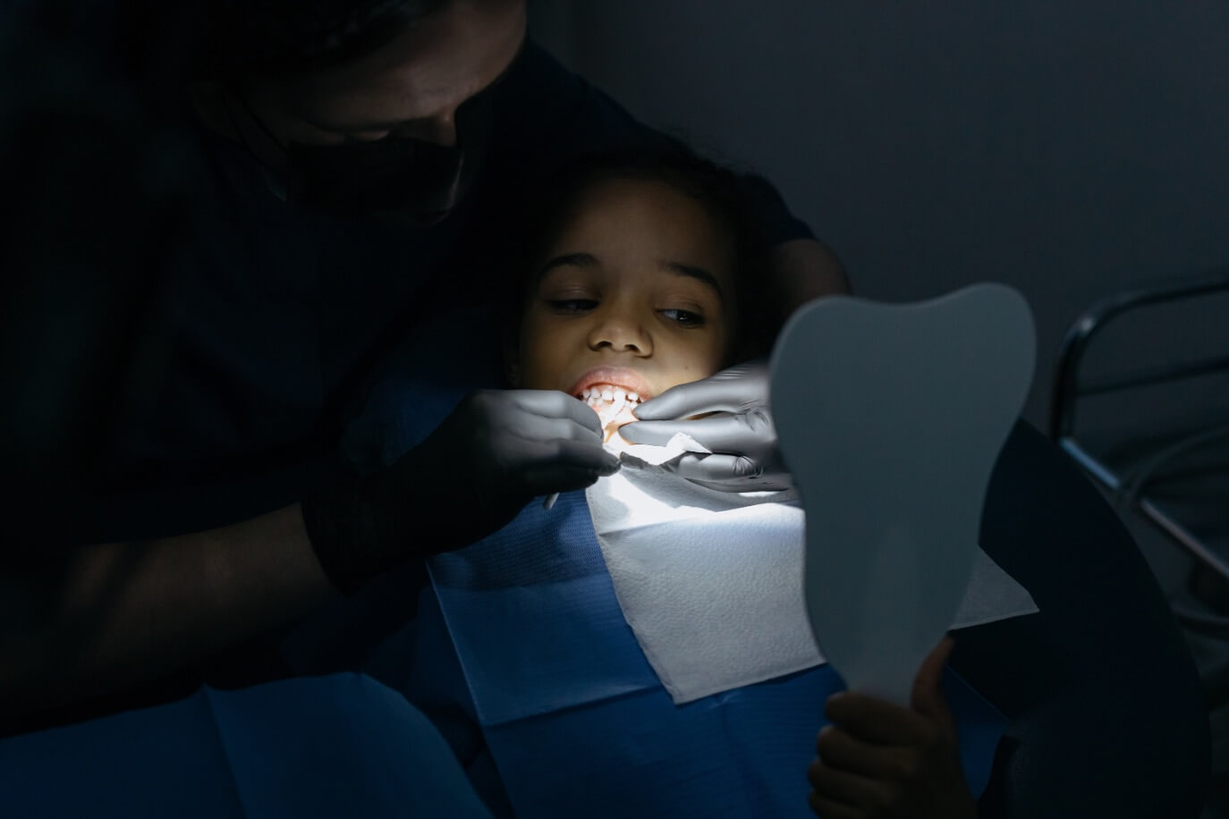 Pediatric dentist in Edinburg TX performing a procedure